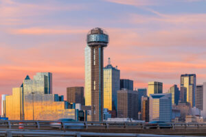 A high-quality image of Reunion Tower from a distance, showcasing the tower’s iconic shape and the surrounding Dallas skyline.